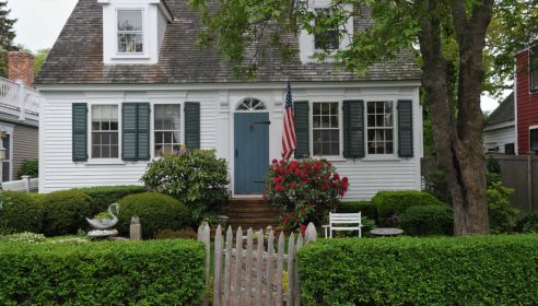 white house with beautiful green yard